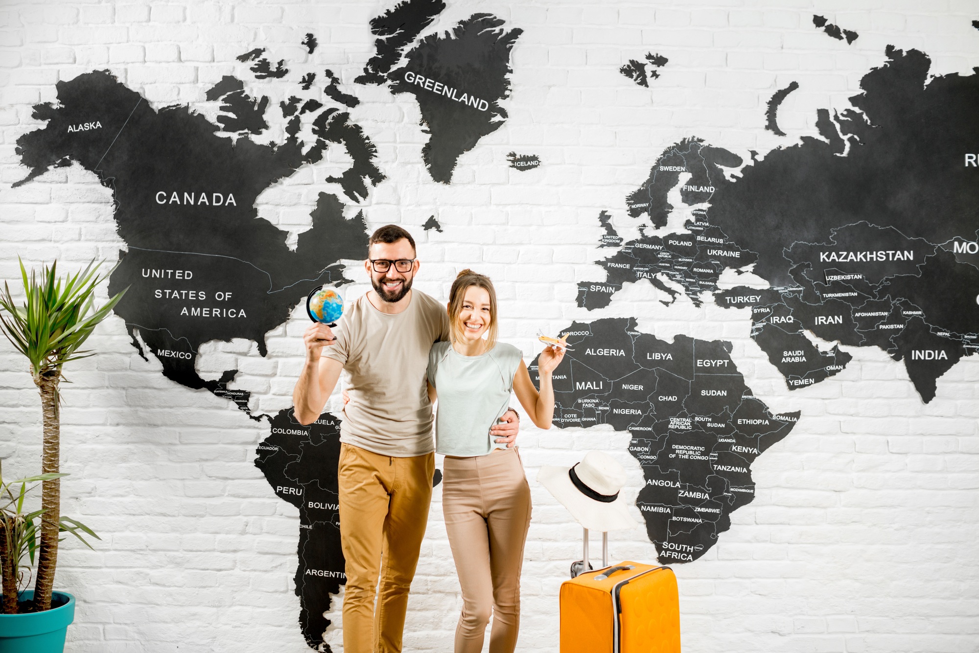 Couple of travelers on the world map background